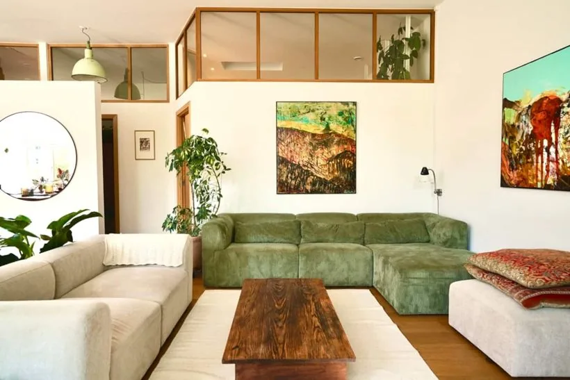 The penthouse living room with the green sofa and artwork
